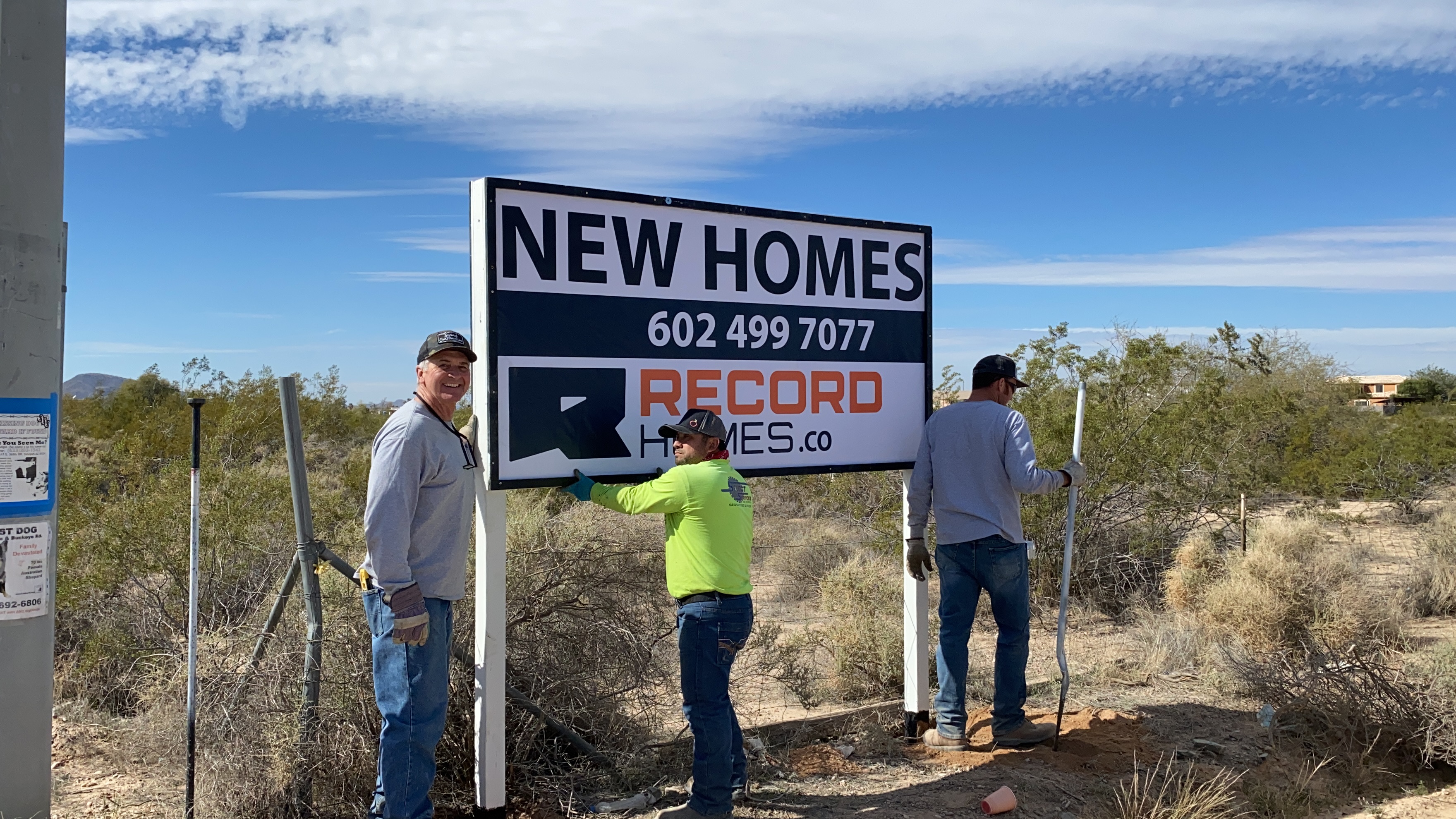 Installing home sign at Record Homes